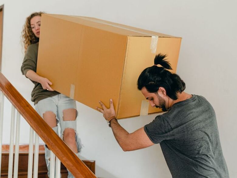 AZ Valley Movers crew moving boxes into a downtown Phoenix high-rise lobby